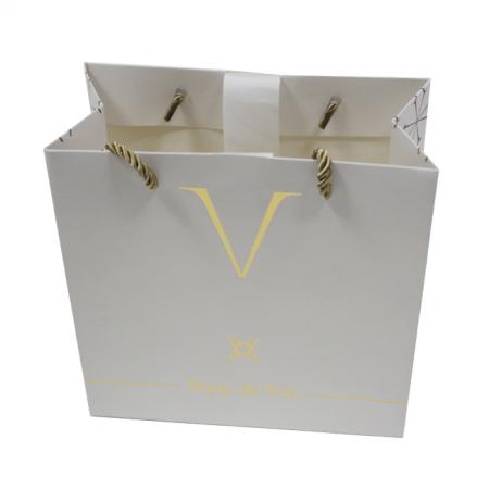 Shopping gold paper gift bag with logo design